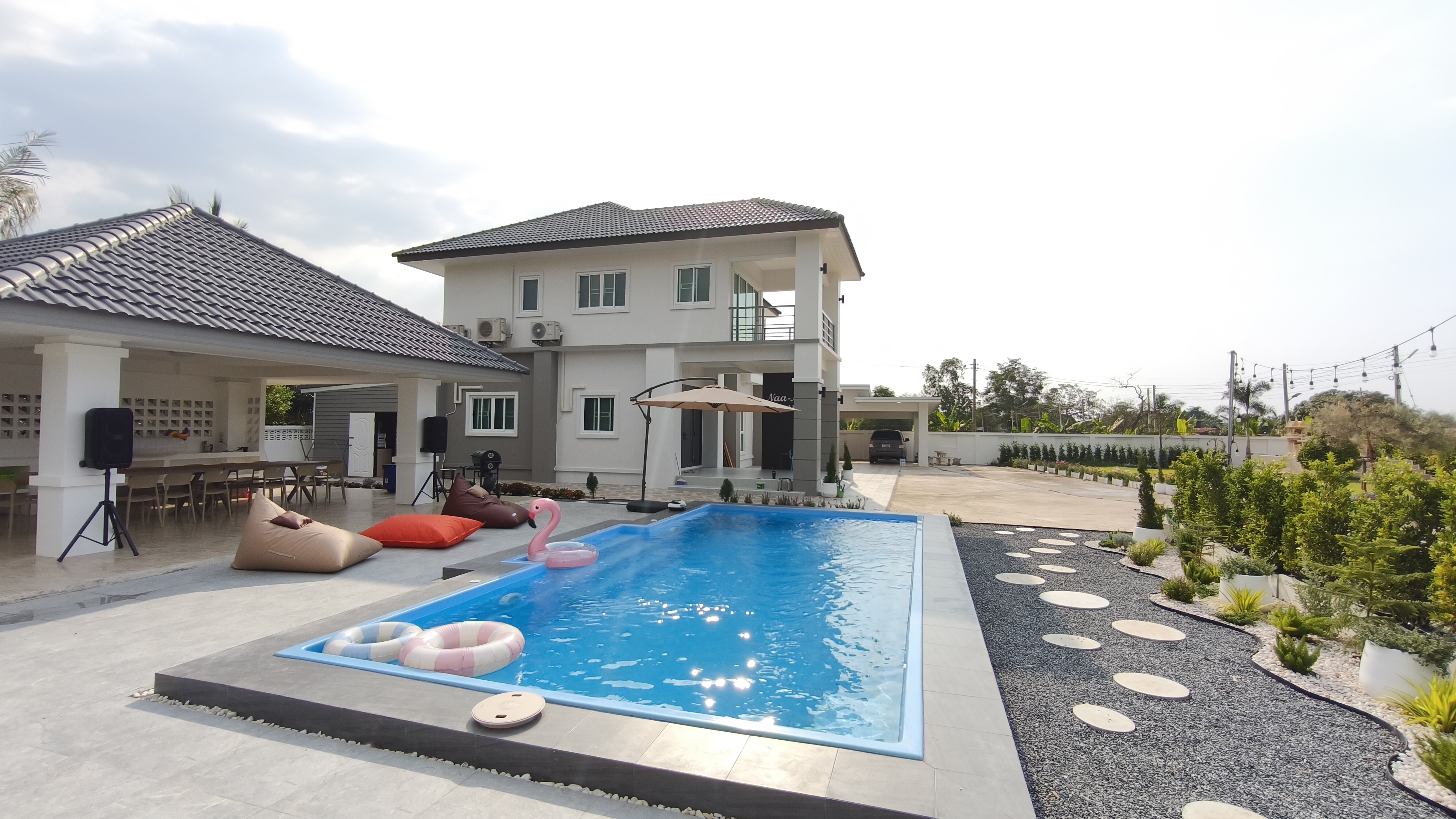 Luxury pool villa exterior with swimming pool and modern architecture